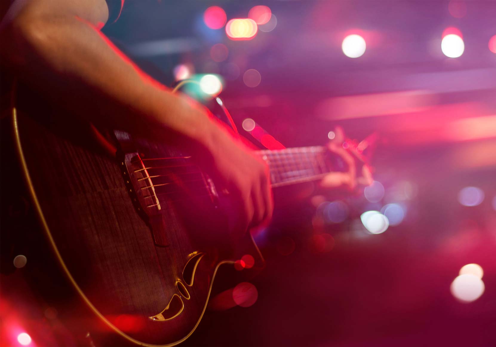 Man playing guitar during an evening show - Nevada Craft Beer Events